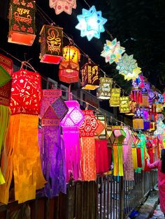 brightly colored lanterns are hanging on the fence