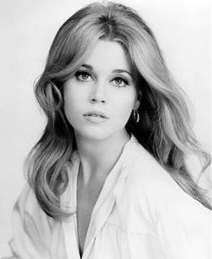 a woman with long blonde hair wearing a white shirt and looking at the camera, with a quote from jane fonda above her