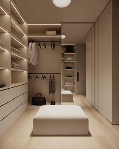 a walk - in closet with shelves, drawers and clothes hanging on the wall next to it