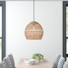 a dining room table with chairs and a basket hanging from the ceiling