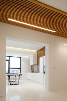 an empty room with white walls and wooden ceiling