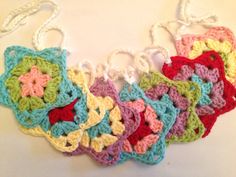 several crocheted squares are arranged in the shape of an ornament on a white surface