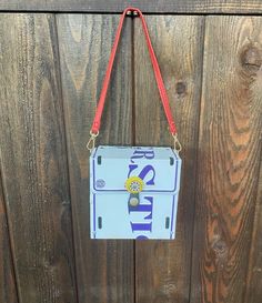 LSU Tigers License Plate Purse w/ Red Strap  Marked Officially Licensed Collegiate Products lined with black fabric 49x95 2145 6 1/8'' x 6 1/8 2 1/2''  Very good condition. Cute bag! We are happy to answer any questions. Please check all photos. All sales are final.  Thanks for shopping with us License Plate Purse, Top Handle Bags, Lsu Tigers, Cute Bag, Black Fabric, License Plate, Tigers, Purses And Handbags, Top Handle