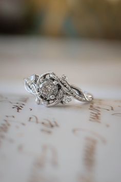 a diamond ring sitting on top of a piece of paper