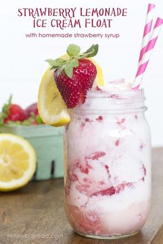 strawberry lemonade ice cream float in a mason jar with strawberries and lemons