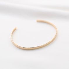 "14K gold cuff bracelet. 14K Gold Minimalist Cuff Bracelet * 14K solid gold. It is about 3mm x 1mm Please select the size of your wrist. If your wrist is 6\", please purchase 6\" bracelet. (If you order a 6\" bracelet, actual cuff length will be 5\" plus 1 inch opening.) Please read our policies before you place your order. https://www.etsy.com/shop/SashJewelry/policy?ref=shopinfo_policies_leftnav To see other Mother daughter necklace set click here: https://www.etsy.com/shop/SashJewelry?section Everyday Gold Hammered Cuff Bracelet, Minimalist Hammered Bangle For Everyday, Adjustable Yellow Gold Minimalist Cuff Bracelet, Minimalist Gold Cuff Bracelet, Tarnish Resistant, Gold Minimalist Cuff Bracelet Tarnish Resistant, Everyday Gold Open Cuff Bracelet, Minimalist Adjustable Yellow Gold Cuff Bracelet, Minimalist Tarnish Resistant Cuff Bangle, Gold Minimalist Tarnish-resistant Cuff Bracelet