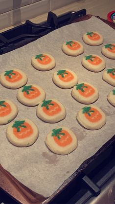 the cookies are decorated with carrots and green leaves