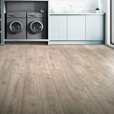 a washer and dryer in a room with wood flooring on the walls