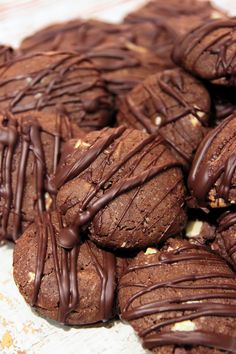 cookies with chocolate drizzled on them sitting on a table