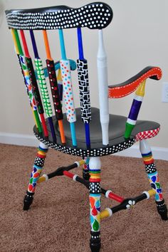 a chair made out of different colored crayons and pencils sitting on the floor