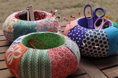 several different types of fabric covered objects on a wooden table with grass in the background