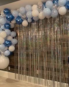 blue and white balloons hanging from the ceiling