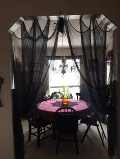 a dining room table covered in black net