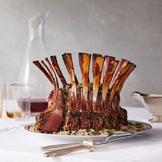 a large piece of meat sitting on top of a plate next to utensils