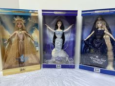 three barbie dolls are shown in their boxes