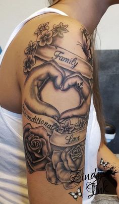 a woman with a tattoo on her arm holding a heart and two hands in the middle