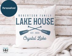 personalized lake house pillow with two paddles on it and the words, robertson family lake