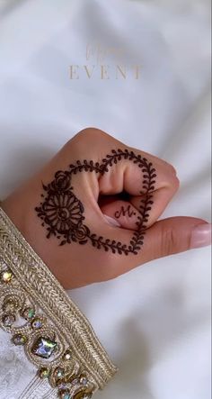 a woman's hand with henna on it and the word love written in the middle