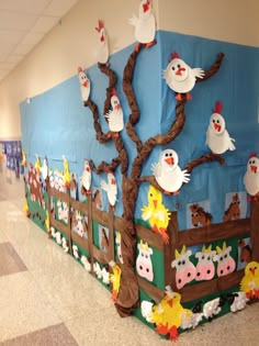 a bulletin board with farm animals on it and trees in the center, along with other decorations