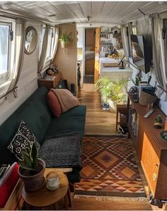 a living room with couches, tables and windows on the side of the wall