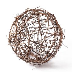 a ball made out of twigs on a white background