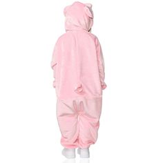 a person in a pink teddy bear onesuit is standing on one leg and wearing white socks