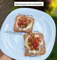 two pieces of bread with different toppings on them, sitting on a white plate