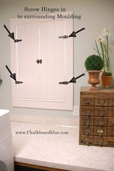 an image of a bathroom setting with arrows pointing in to the wall and drawers on the counter