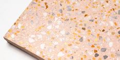 a close up view of a counter top with different colored rocks on it and white background