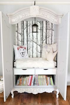 a white bench with books on it in front of a wallpapered tree pattern