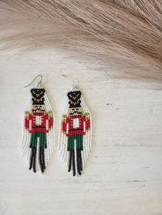 Hand beaded glass bead earrings. Hypoallergenic Hooks Nutcracker Earrings, Beaded Projects, Glass Bead Earrings, Earrings Hypoallergenic, Christmas Patterns, Bead Ideas, Christmas Bead, Christmas Earrings, Black Hat