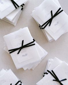 white napkins tied with black ribbon on top of each other and sitting on the floor