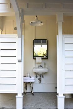 a white sink sitting under a mirror in a bathroom