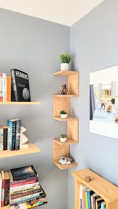 the bookshelves are filled with books in this small room that is painted light blue