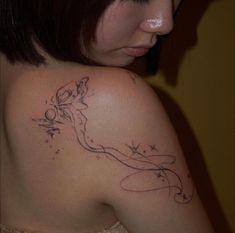 a woman with a tattoo on her shoulder