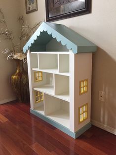 a doll house sitting on top of a hard wood floor