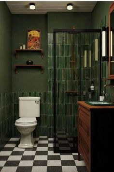 a bathroom with green walls and black and white checkered flooring, a toilet in the corner