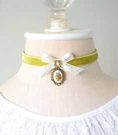 This colorful cameo choker necklace is handmade with a soft double sided chartreuse green velvet ribbon. It features a vintage lace and silk ribbon bow, a pearl bead flower jewel and a beautiful vintage floral cameo pendant with a colorful posy bouquet of flowers. See last photos for coordinating designs available separately in the Rosy Posy Designs shop... a fun group gift for mothers, daughters, sisters and friends! * Size ~ Adjustable length 12.75 - 15.5 inches with extender chain Please chec Vintage Ribbon Choker As A Gift, Vintage Ribbon Choker As Gift, Elegant Ribbon Choker As Gift, Vintage Ribbon Necklace For Gift, Elegant Yellow Choker As A Gift, Elegant Yellow Choker For Gifts, Vintage White Choker For Gift, Vintage Green Adjustable Choker, Green Adjustable Vintage Choker