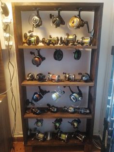 there are many different types of fishing reels on this shelf