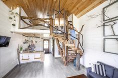 a living room filled with furniture and a spiral staircase