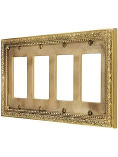 an ornate gold metal switch plate cover with three ganging plates on the front and sides