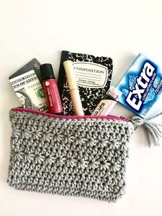 a crocheted pouch with toiletries in it