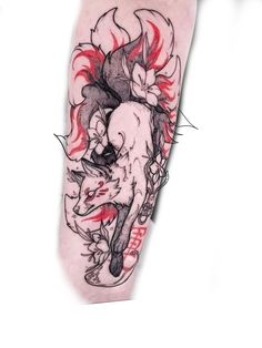 an arm with some tattoos on it and a demon in the middle, sitting next to another