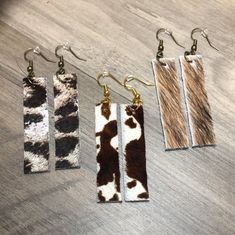 Each item in my store is handmade and designed with you in mind -- no 2 items are the same! These earrings are perfect for every occassion, and can easily dress up any outfit! This specific pairs are:  *Approx. 2.1 inches from top of leather to bottom (approx. 3 inches from top of earring hook) *Approx. .5 inches wide at its widest point (size varies slightly) *Real hair on hide, cowhide leather Hide Earrings, Leather Crafting, Real Hair, Cow Hide, Bar Earrings, Leather Craft, Cowhide Leather, No. 2, Jewelry Earrings Dangle