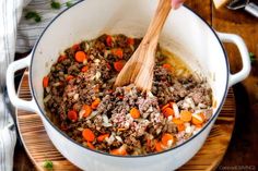 a pot filled with ground beef and carrots