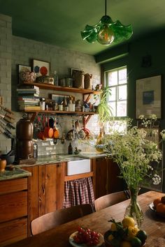 a kitchen filled with lots of counter top space and wooden furniture next to a window