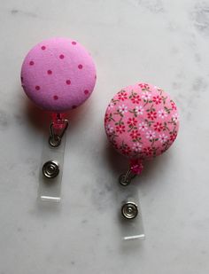 Pink Retractable ID Badge, Pink Floral Holder Reel, Pink Polka Dots Belt Clip, Nurse Reel, Badge Holder, Fabric Reel Holder, Girly Reel Clip Check out this stylish pair of ID badge reel, retractable ID badge holder will add some stylish flair to your name badge. Very easy to use.... just clip your badge on and slide the clip into place! Be sure to pick up a couple so you can change these out with your mood, outfits or the seasons. The reels are made to order, so fabric placement may vary.  PRODUCT DESCRIPTION & MEASUREMENTS: Colors of reels: hot pink, blue, green, pink and white Sturdy clip-on retractable id badge holder with a silver tone clip Retractable cord measures approx. 26 inches in full length Approx: 1 1/4" wide length is approx. 3 1/2" inch Attached securely is a fabric covered Mood Outfits, Retractable Id Badge Holder, Id Badge Reels, Name Badges, Fabric Covered Button, Id Badge Holders, Belt Clip, Key Fobs, Pink Polka Dots