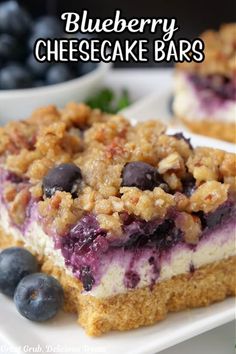 blueberry cheesecake bars on a white plate