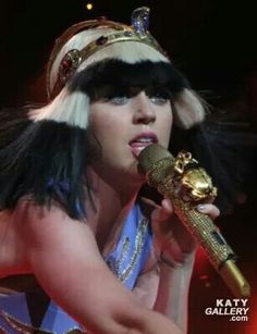 a woman in costume holding a microphone