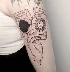 a woman's arm with tattoos on it and an image of the sun in her pocket